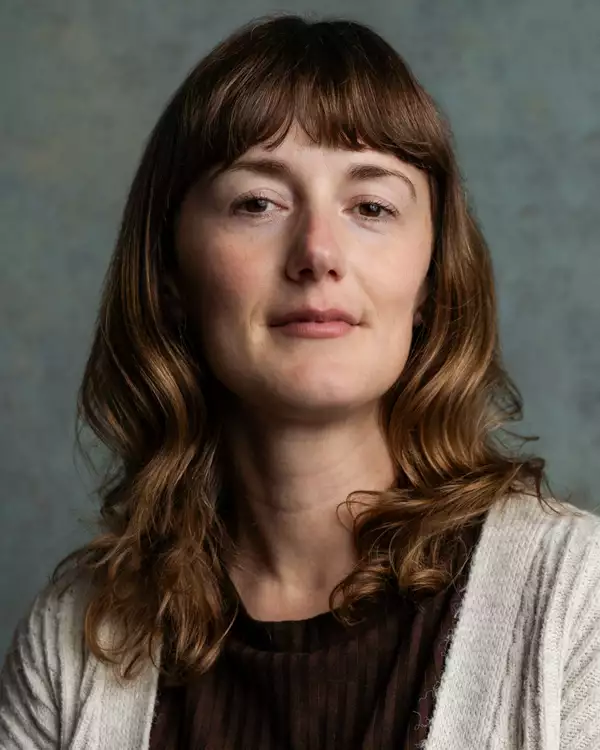 Headshot of Charlotte Sutton CDG wearing a black top and grey cardigan