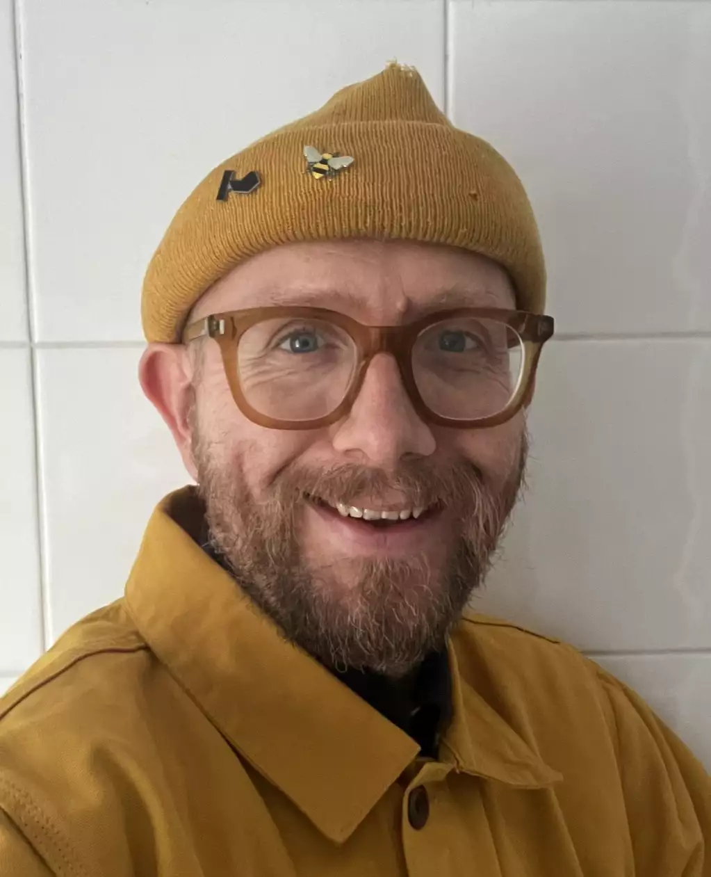 Josef Minta wearing a mustard yellow hat and shirt