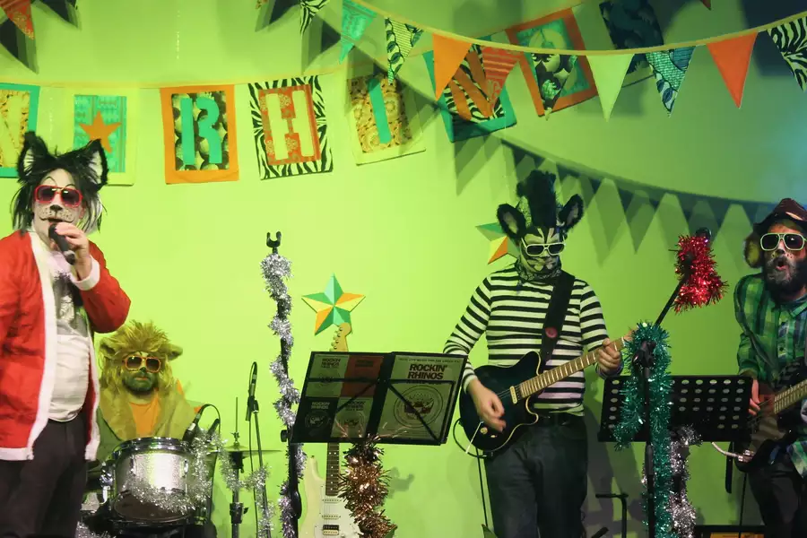 Four members of the Rockin Rhino's performing on stage dressed as animals