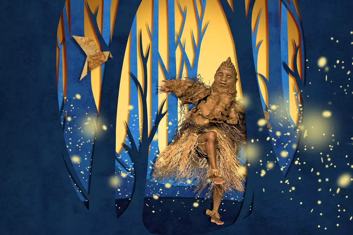 A dancer wearing a light brown costume and puppet mask, moves in a glowing forest of tall blue and golden trees, surrounded by floating firefly-like lights.