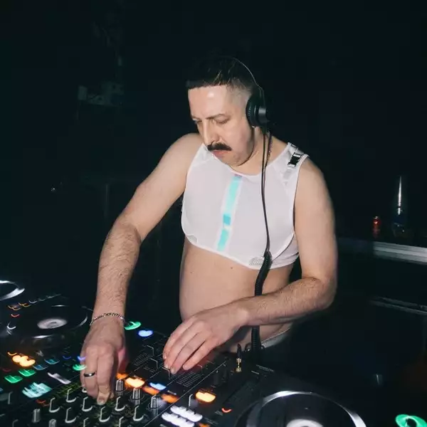 David James DJing in a white crop top