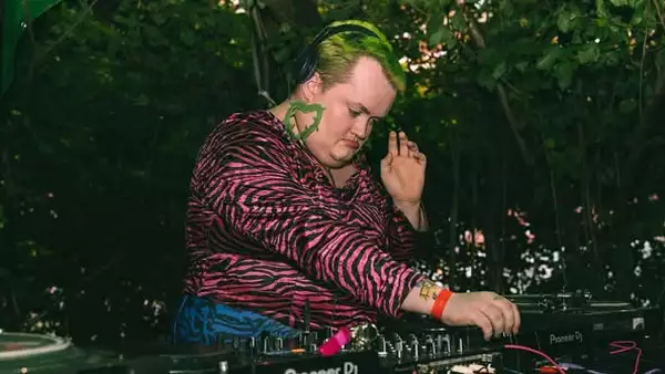 The Fat Britney DJing outside wearing a pink zebra striped top