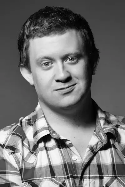 Headshot of Craig Wilkinson wearing a red chequered shirt