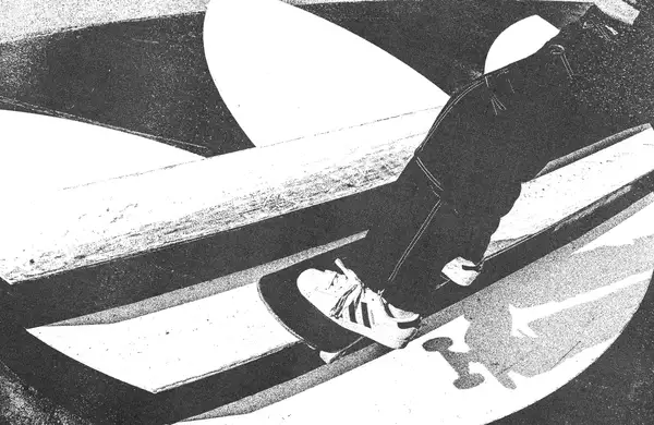 Black and white image of someone skateboarding on an Adidas skate ramp wearing Adidas trainers