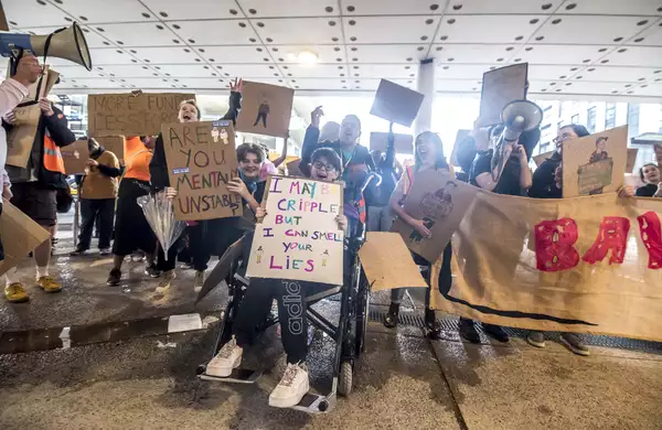 A group of people holding placards at Balmy Army parade