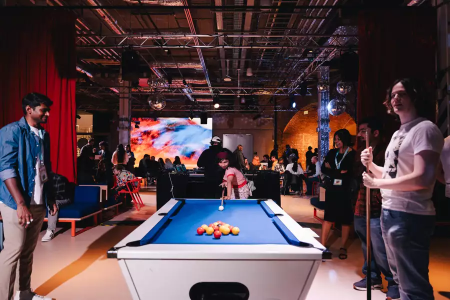 Three people playing pool in the busy Social
