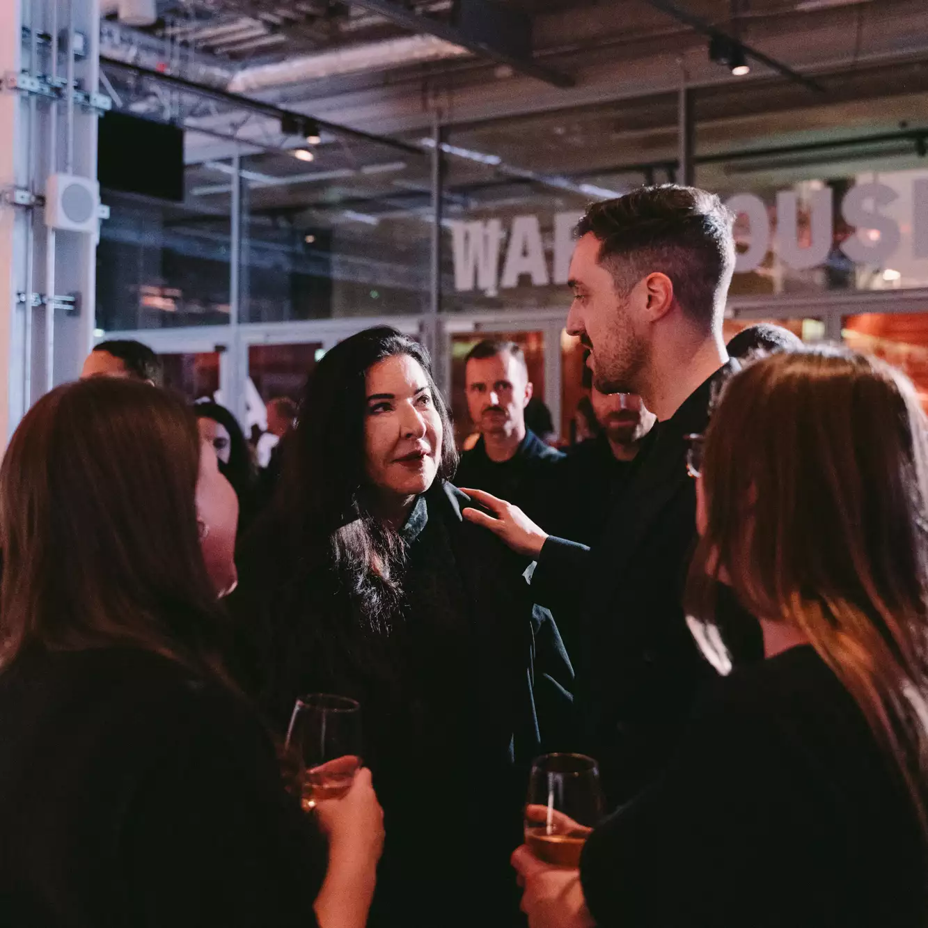 A crowd of people talking to Marina Abramović in the Social