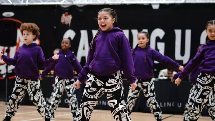 children in purple sweatshirts dancing