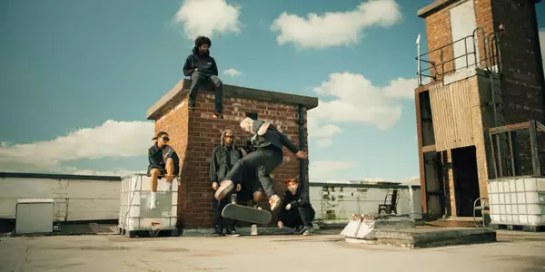 Photo of a group of skateboarders practising on a roof