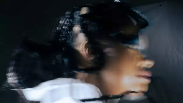 Blurry, distorted picture of Sheri looking to the side