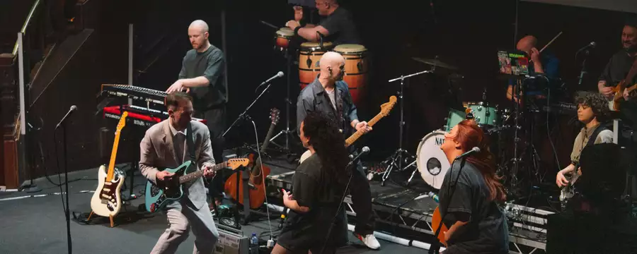 Members of Slippery People performing on stage
