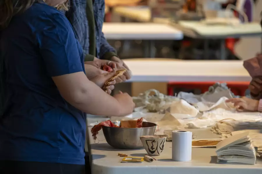 A person stood at a table taking part in a craft workshop