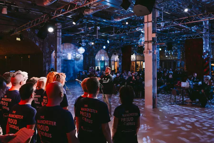 Manchester Proud Chorus performing in the Social with dim lighting and disco balls