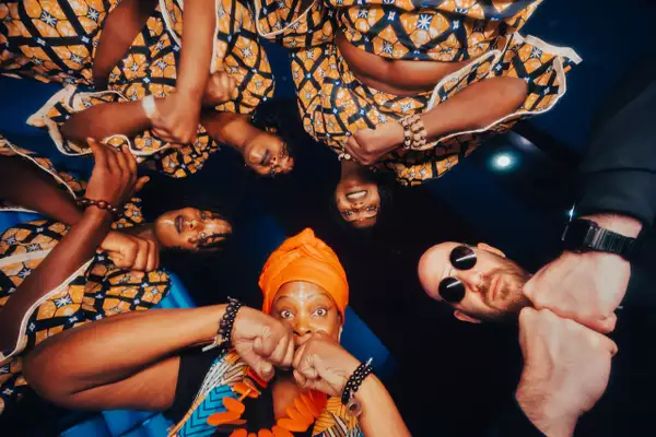 Group photo of Les Mamans du Congo x Rrobin looking down at the camera