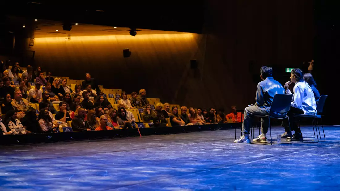 Naqqash Khalid and Nabhaan Rizwan sat on the Hall stage during the Q&A at MUBI FEST, with a large audience watching
