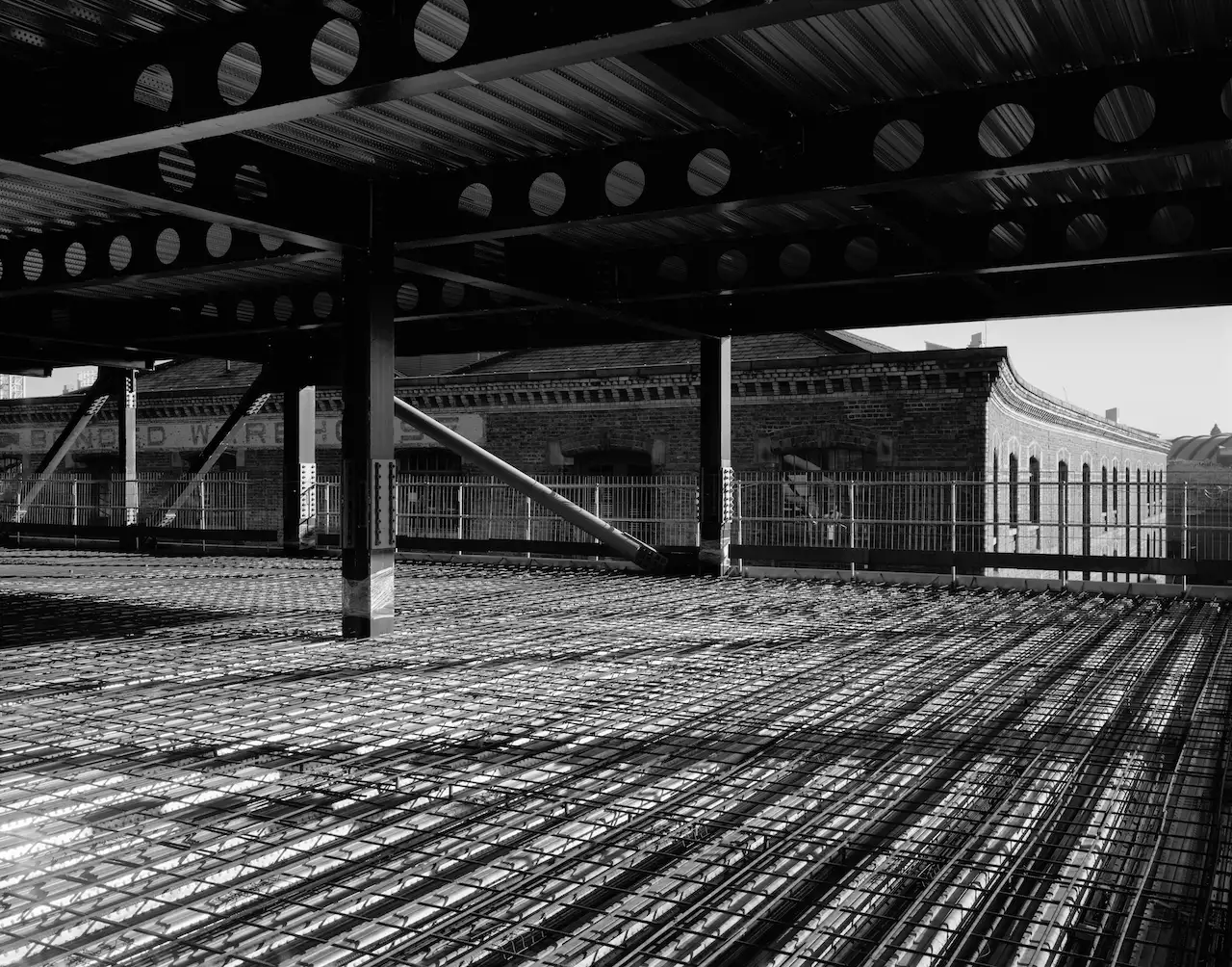 black and white photograph of a steel structure during the Aviva Studios build