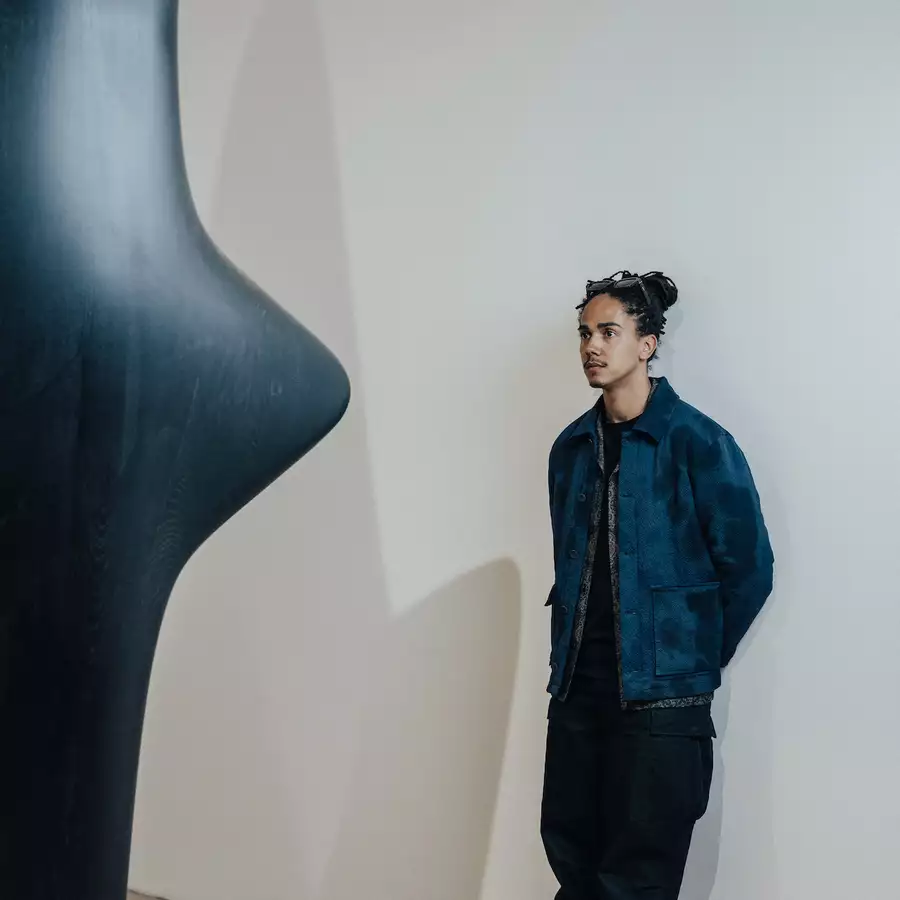 Photograph of Mac Collins with his sculpture