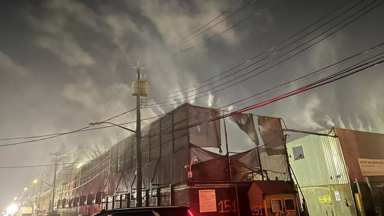 Warehouse buildings and telephone wires at night