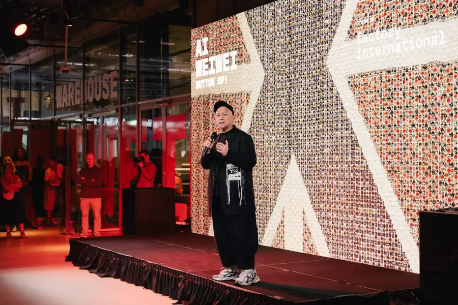 Kee Hong Low stood on the stage in the Social speaking into the microphone