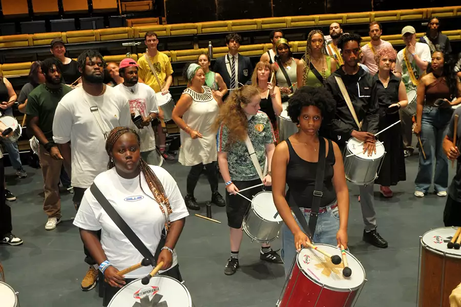 A group of people taking part in a percussion workshop