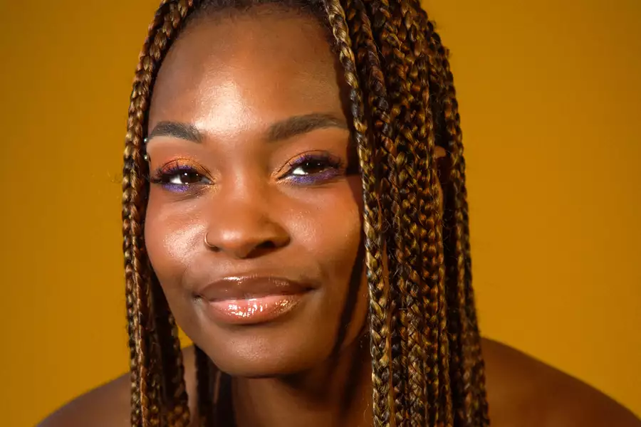 Headshot of Yemi from Untold Quartet on a sandy orange background