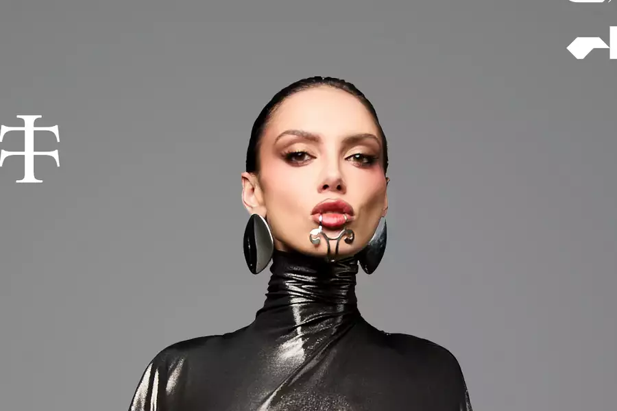 Sara Landry on a grey background wearing black leather