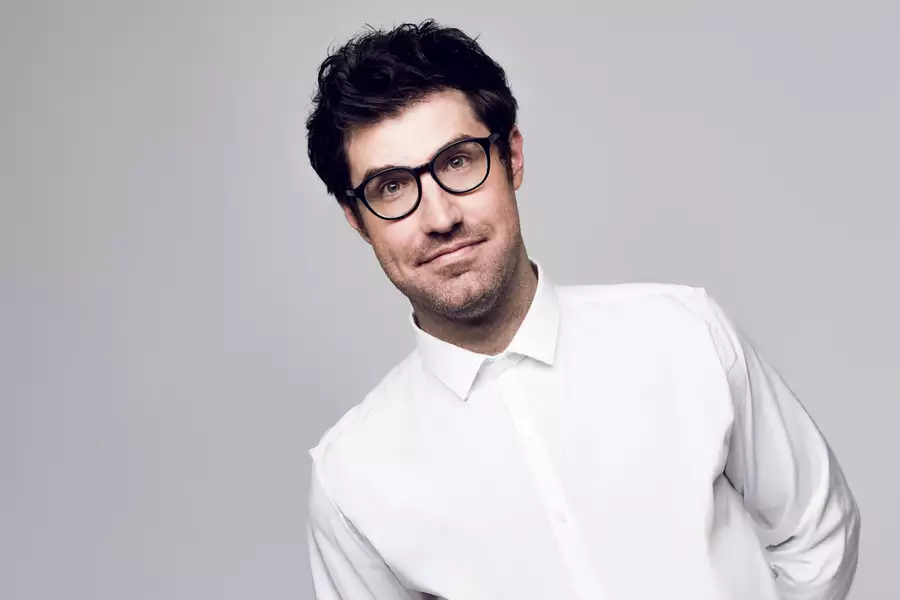 Headshot of Dan Schreiber on grey background