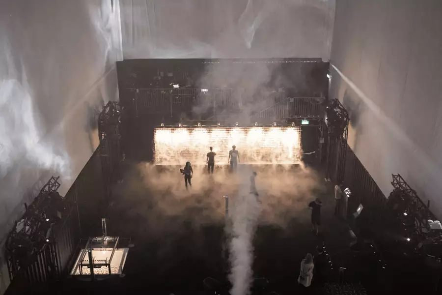Behind the scenes at an MIF production being set up. Dark with smoke and moody lighting