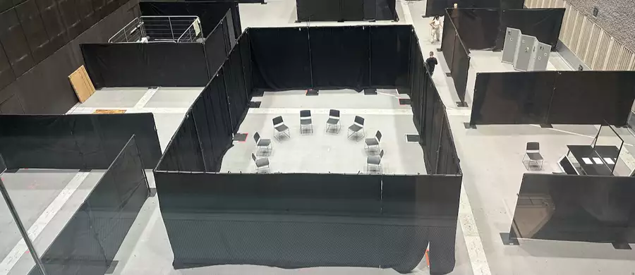 A photo of the various stations in the Warehouse, taken from above. It shows sectioned areas.