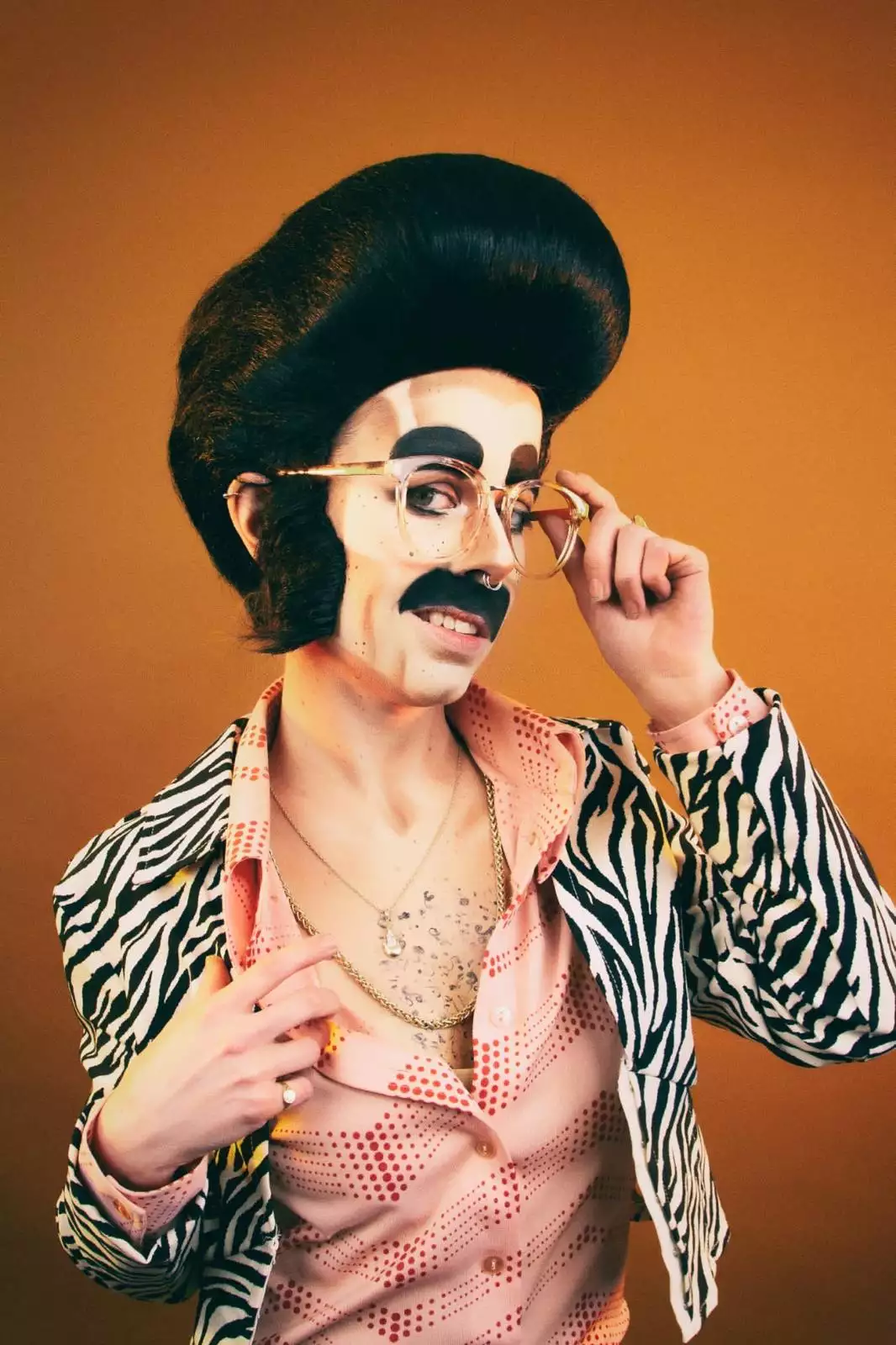 The Vicar's Daughter from Canal St Kings wearing a zebra jacket on an orange background