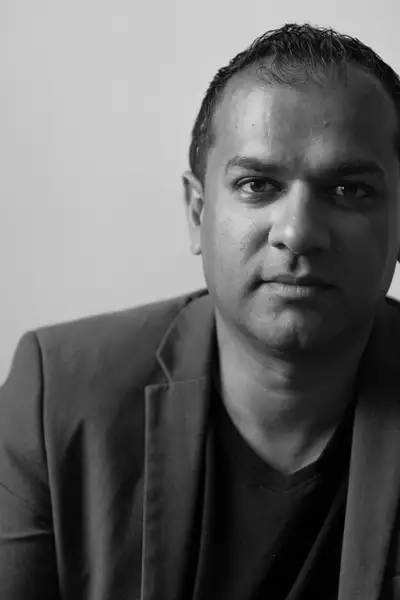 Black and white headshot of Shaun Comerford wearing a blazer