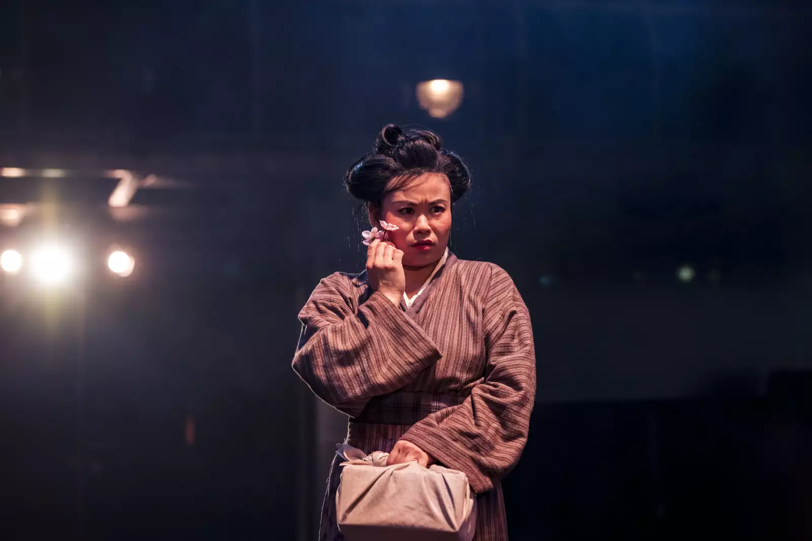 Photo of Mei Mac holding a flower up to her face