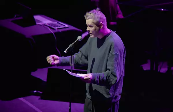 Max Porter performing on stage at Aviva Studios with purple lighting