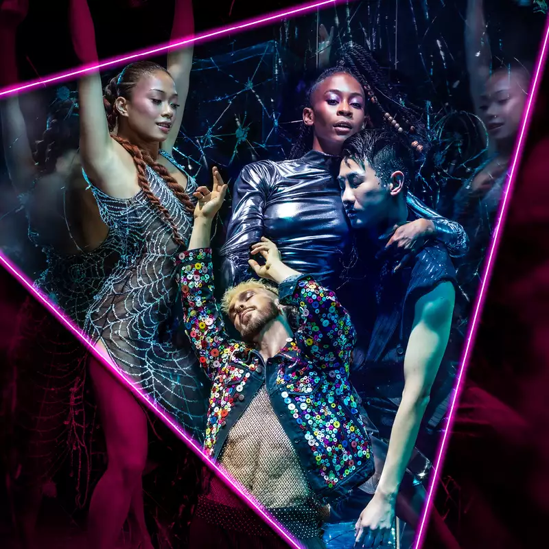 Neon-lit dancers posing inside a glowing triangle frame at a nightclub.