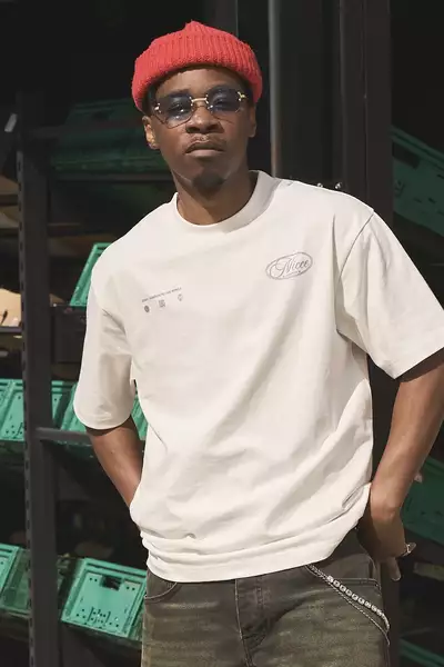 PRIDO wearing a white t-shirt and red hat