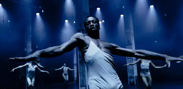 A dancer in a nightclub wearing a silver costume