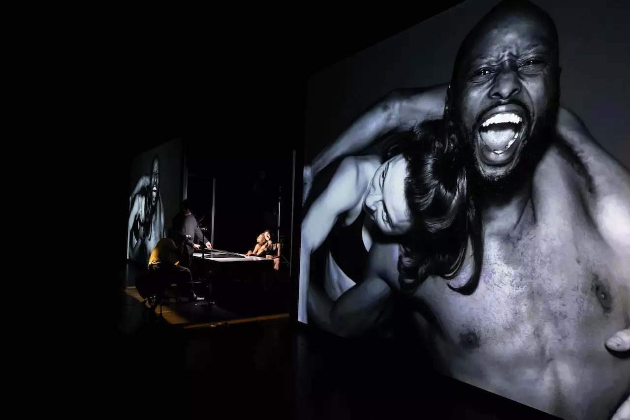 A black and white photograph of two people by Benji Reid on a screen