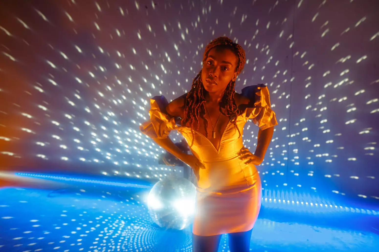 B!TEZ stands in front of a disco ball photographed by Marieke Macklon