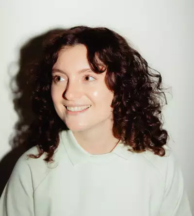 Brit Seaton wearing a white jumper on a white background