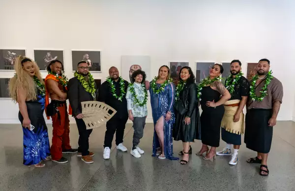 A photo of the artists in FAFSWAG collective standing in Māngere Arts Centre in front of a white gallery wall