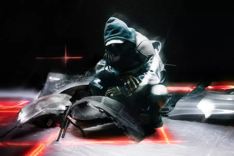 A person wearing all black with their hood up. They are crouching on the floor surrounded by fragments of a broken vehicle.