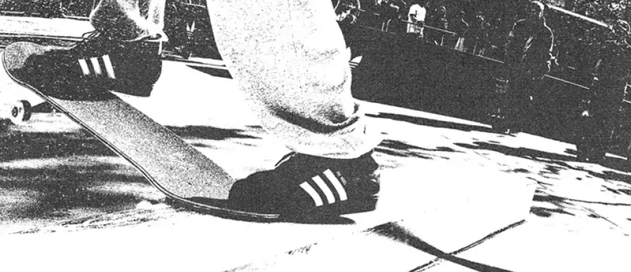 Black and white image of someone skateboarding on an Adidas skate ramp wearing Adidas trainers