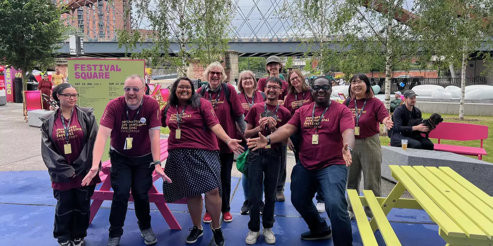 A group of volunteers smiling and laughing at Manchester International Festival 2025