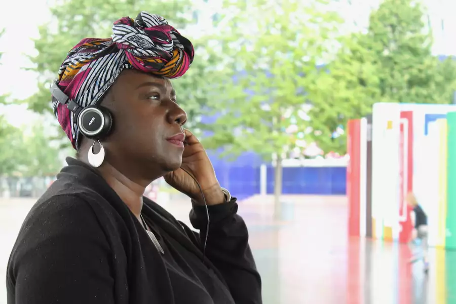 A person with headphones on looking to the side