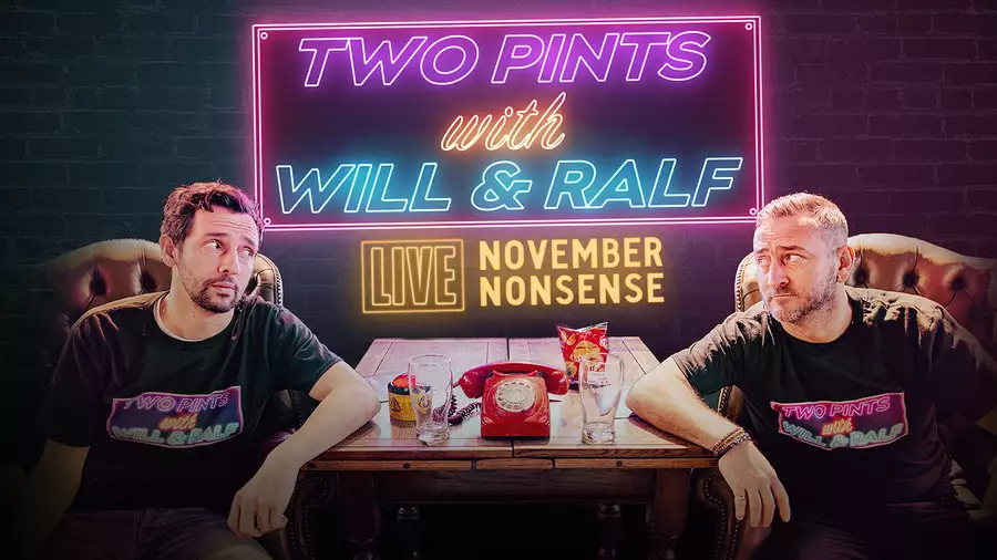 A promotional poster for Two Pints with Will & Ralf – LIVE: November Nonsense. Will Mellor and Ralf Little sit in a pub-like setting, wearing matching black T-shirts with the show's logo. A wooden table between them holds pints, a red phone, and snacks. The background features a dark brick wall with neon-style signage in pink, blue, and yellow displaying the show's title.