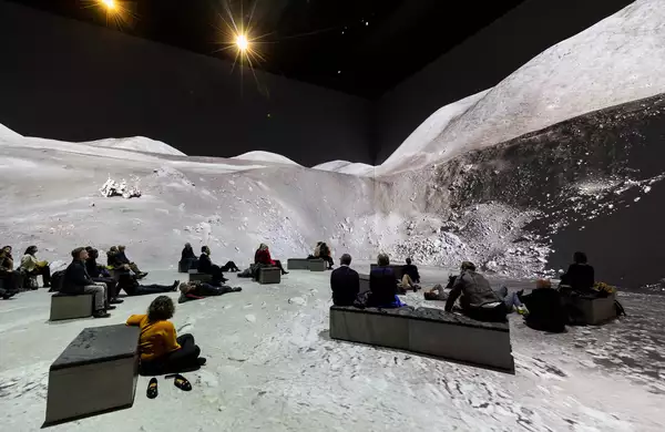 People watching The Moonwalkers, showing a scene on the moon