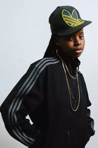 Ramiyah Kofi wearing a black Adidas jacket and hat
