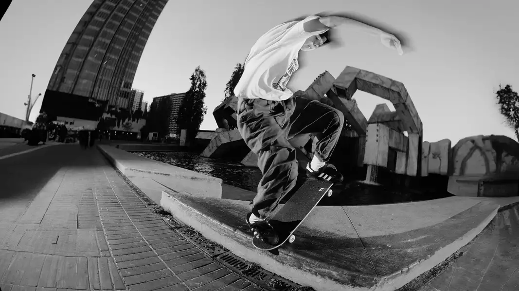 Black and white photograph of a skateboarder mid-trick
