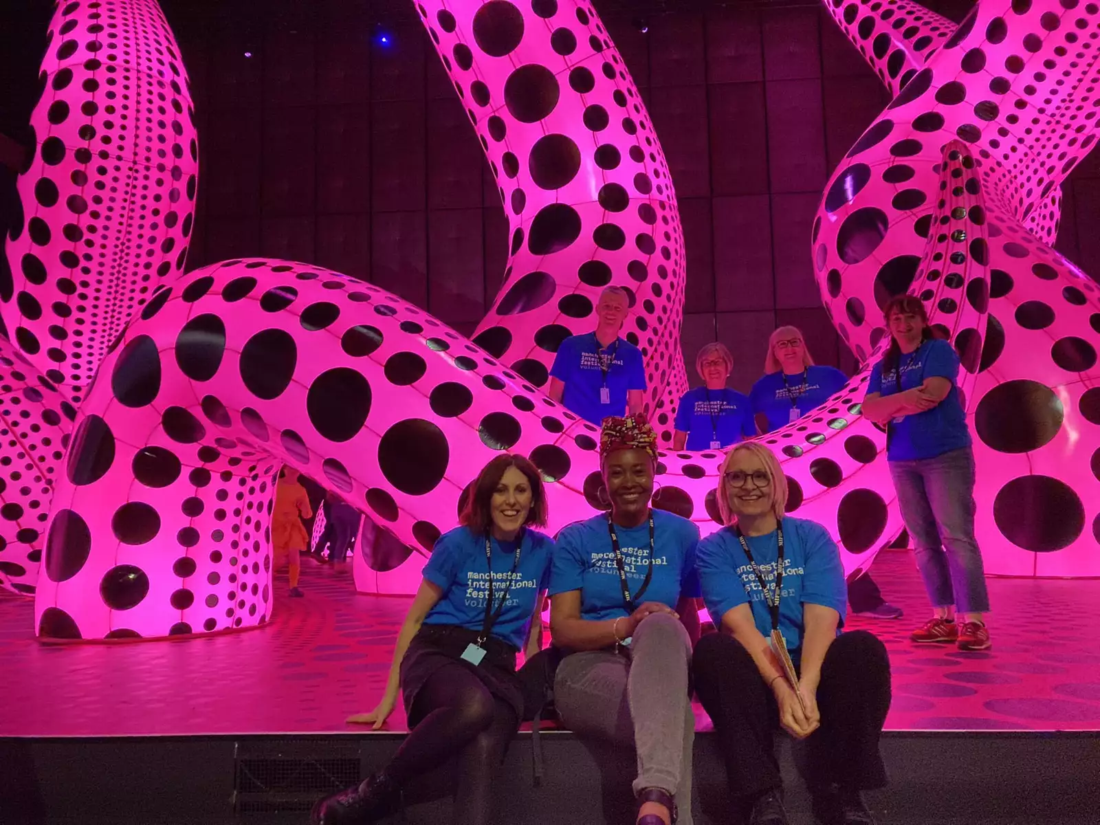 A group of volunteers in the Yayoi Kusama You Me and the Balloons exhibition