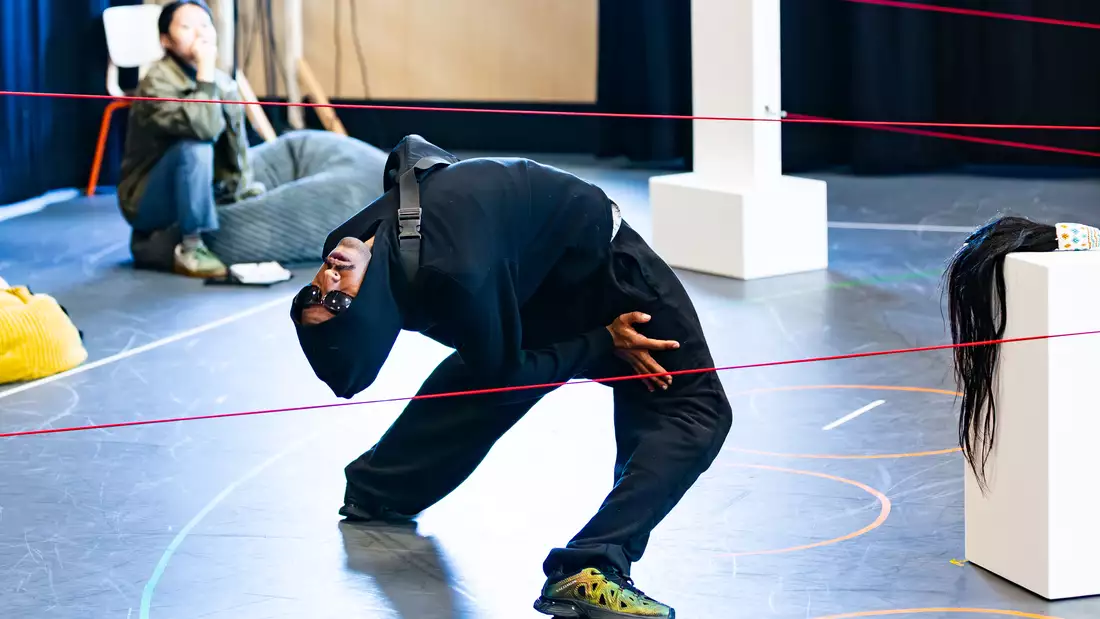 A dancer bending their back in a rehearsal room for Return to the Forest